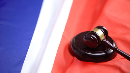 Gavel lying on sound block on flag of France, national court decision, order
