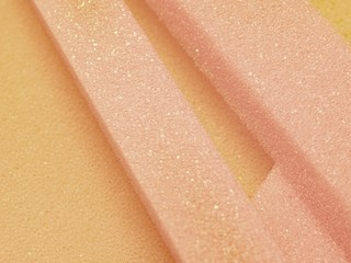 Fototapeta premium White pink artificial foam, soft texture on a light background.