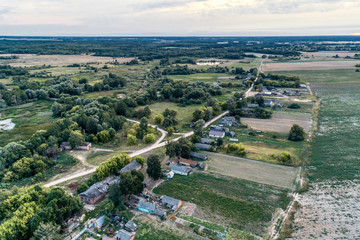 Rural landscape from the air. Many small rural houses. Village streets are shared by a shallow lake.