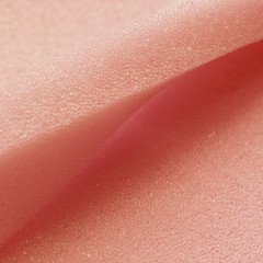 Fototapeta premium White pink artificial foam, soft texture on a light background.