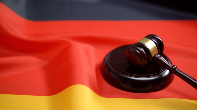 Gavel lying on sound block against german flag, national legal system, law