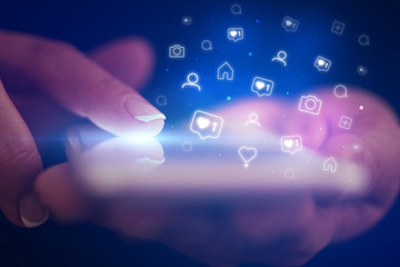 Finger touching phone with social media concept and dark background