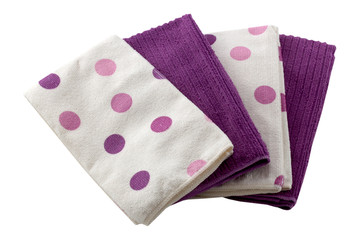 Set of microfiber dust cloths in purple and white with polka dots. Cloths are on a white background.