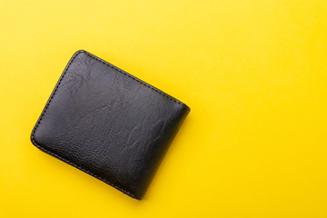 wallet on yellow background with space for text. From above