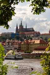 Naklejka na ściany i meble Scenic panorama cityscape view of Moldava river boat Prague in Czech Republic.