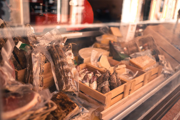 Italian window counter with delicious parmesan cheese, italian culture. Ancient cozy streets with restaurants and bars
