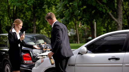 Stressed woman calling police standing car collision scene near drunk driver © motortion