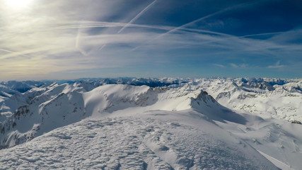Naklejka na ściany i meble Beautiful and serene landscape of mountains covered with snow in Mölltaler Gletscher, Austria. Thick snow covers the slopes. Clear weather. Perfectly groomed slopes. Massive ski resort. Glacier skiing