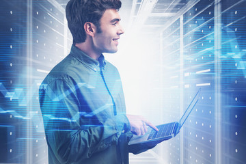 Smiling young programmer in data center