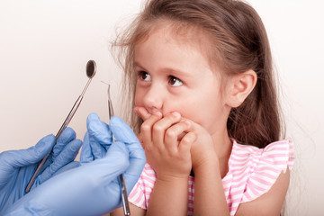Dental medicine and healthcare - dentist examining little child girl patient open mouth showing...