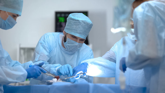Surgeon team working in operation room, performing cardiothoracic surgery