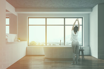 Young woman in white luxury bathroom