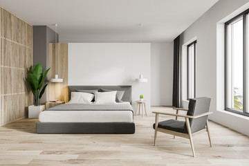 White master bedroom with armchair