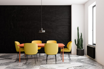 Black and white dining room with bright chairs