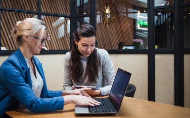 young HR woman interviews a candidate for a job. Business meeting two young women at work discussing the project