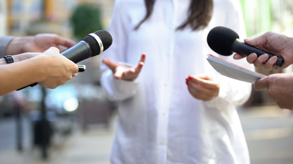 Female politician talking on media press conference, public relations, event - 295362931