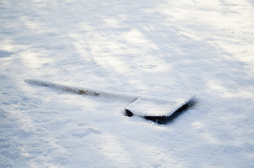 wooden snow shovel covered with snow