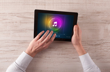 Hand touching tablet with music play concept