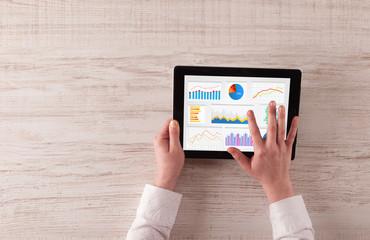 Hand making diagrams and charts on tablet