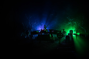 Scary view of zombies at cemetery dead tree, moon, church and spooky cloudy sky with fog, Horror Halloween concept. Toned