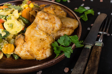 Fried chicken fillet with vegetables.
