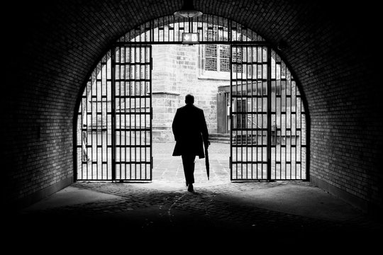 silhouette of man in jail