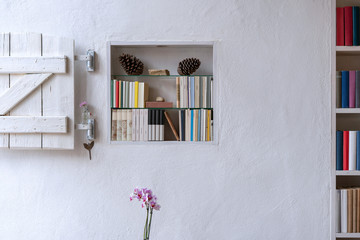 Beautiful bookcase in wall with wonderful orchid