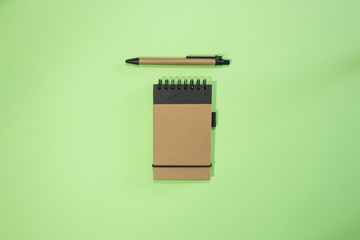 Brown notebook in green background