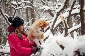 Fototapeta na wymiar Portrait with a cute fluffy puppy. Winter walk with a dog.
