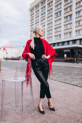 Fashionable beautiful young blondie woman posing in trendy fashionable coat outdoors. Beauty, fashion, modeling concept