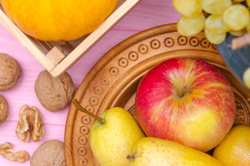 Autumn fruit and flowers, autumn organic fruits on table - autumn harvest.