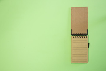 Brown notebook in green background