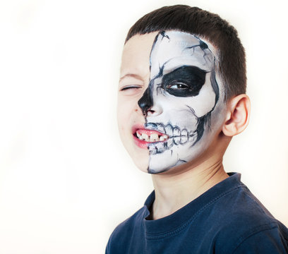 little cute boy with face paint like skeleton to celebrate halloween, lifestyle people concept