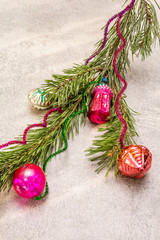 Vintage Christmas tree toys. New Year holiday concept. Evergreen pine branch, sunny rays