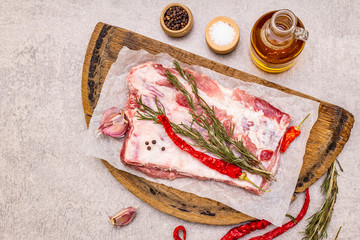 Raw pork ribs with rosemary, chili, garlic, salt and olive oil