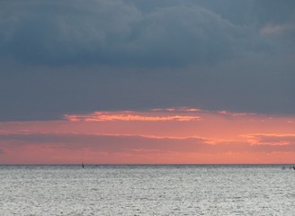 low gray clouds over the sea on a cold autumn evening