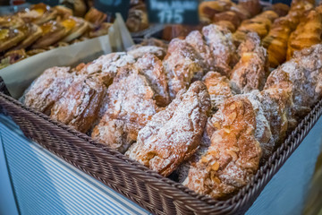 Assortment of delicious shortcrust freshly baked sweet and puff pastry for sale on counter of shop, grocery, market, cafe or bakery. Dessert, food and traditional french cuisine concept