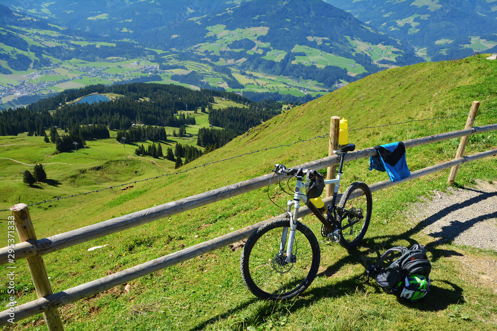 Sticker Hohe Salve mountain view and a bike near a wooden fence, Austrian alps