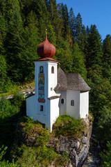 Beautiful small white Saint Mary Church on the rock mountains in Soell ,  in Tirol, Austria