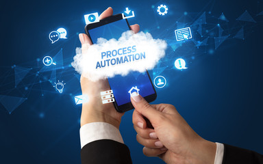 Female hand holding smartphone with PROCESS AUTOMATION inscription, cloud technology concept