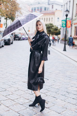Fashionable beautiful young blondie woman posing in trendy fashionable coat outdoors. Beauty,...