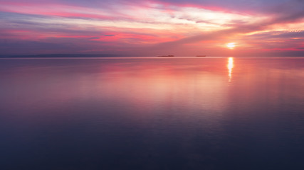 early morning sunrise on a choppy river / wind early spring landscape