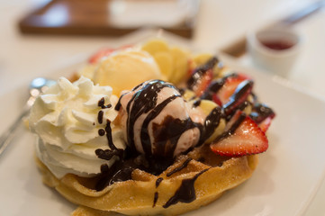 Sweet and cold dessert. Icecrean with toast and chocolate and wip cream