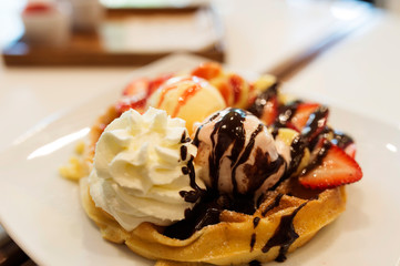Sweet and cold dessert. Icecrean with toast and chocolate and wip cream