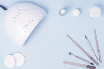 Bubbles with varnish on an insulated surface with LED lamp and a set of tools for nail extensions