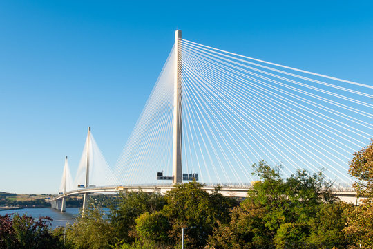 Queensferry Crossing Bridge in North Queensferry near Edinburgh. North Queensferry is located ten miles west of the center of Edinburgh in Scotland. Sunny day, blue sky in the background. © Kristin Greenwood