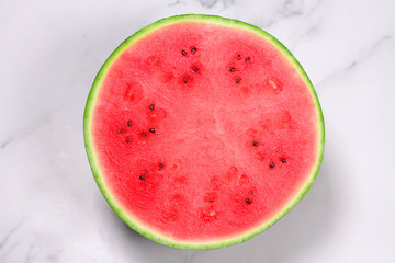 Cut slice of watermelon inside view isolated on white marble background