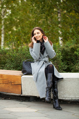 Fototapeta premium Beautiful young brunette woman calling by phone