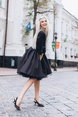 Obraz premium Fashion photosession of professional model in the city in trendy black dress. Fashion , trendy concept