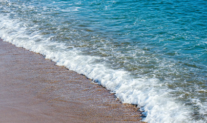 Soft wave of sea on sandy beach. Background.